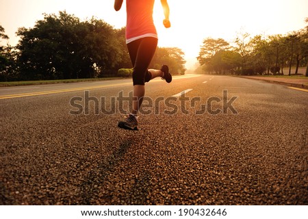 Runner athlete running at road. woman fitness sunrise jogging workout wellness concept.