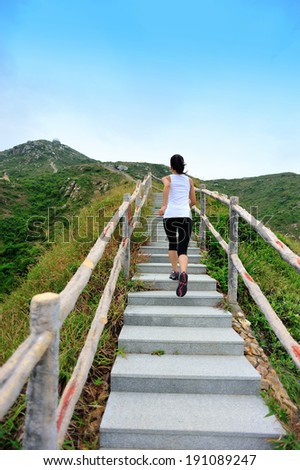 Runner athlete running at mountain stone stairs. woman fitness jogging  workout wellness concept.