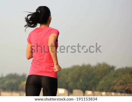 Runner athlete running at seaside. woman fitness jogging  workout wellness concept.