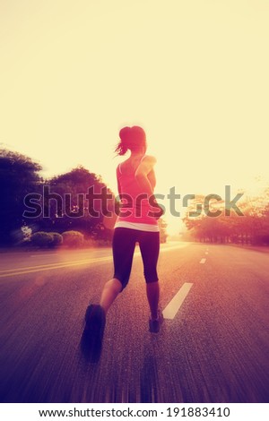 Runner athlete running on road. woman fitness sunrise jogging workout wellness concept.