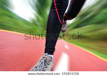 woman runner athlete legs running on road. woman fitness jogging  workout wellness concept.