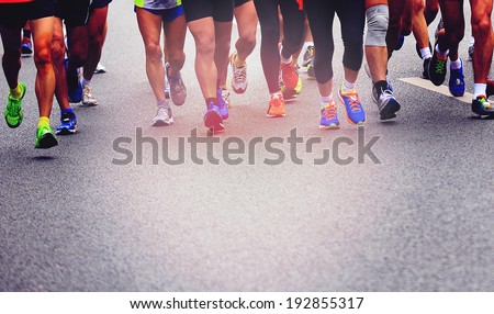 marathon athletes competing in fitness and healthy active lifestyle feet on road