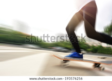 blurred speeding skateboarding woman on zebra crossing road