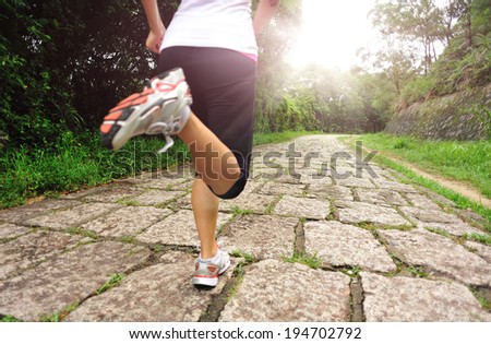 Runner athlete running on sunrise road. woman fitness jogging workout wellness concept.