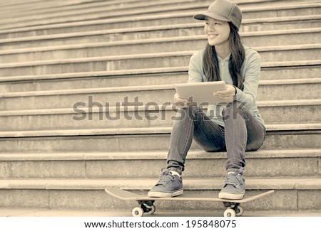 woman skateboarder use digital tablet sit on stairs