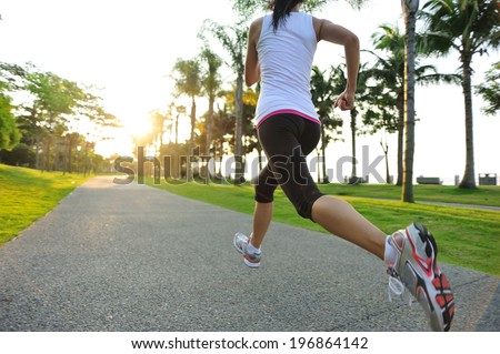 runner athlete running at tropical park woman fitness sunrise jogging workout wellness concept runner athlete running at tropical park woman fitness sunrise jogging workout wellness concept