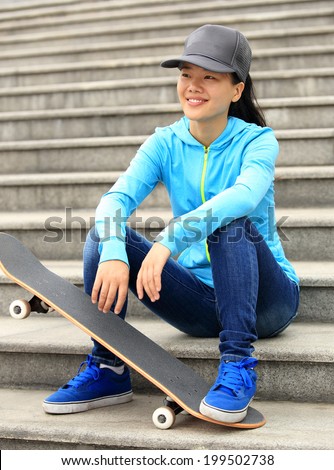 woman skateboarder sit on stairs