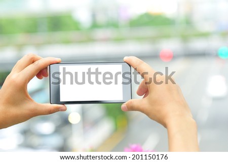 woman hands hold smart phone in modern city