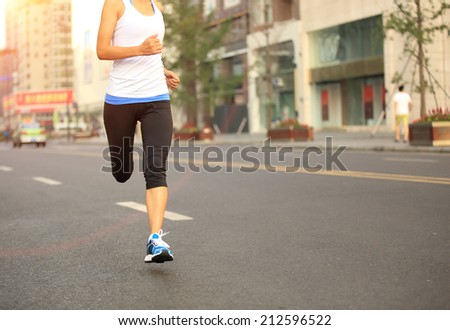 Runner athlete running on city road. woman fitness jogging workout wellness concept. unfocused