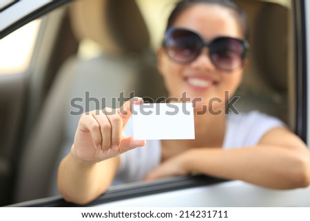woman driver sit in car hold one blank business card