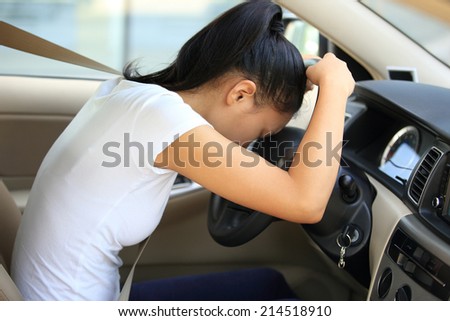 sad woman driver in car