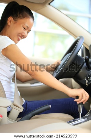 woman driver shifting the gear stick and driving a car