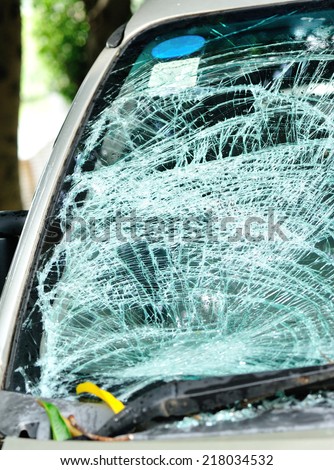 broken windshield of car by typhoon