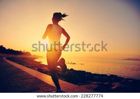 Runner athlete running at seaside. woman fitness silhouette sunrise jogging workout wellness concept.