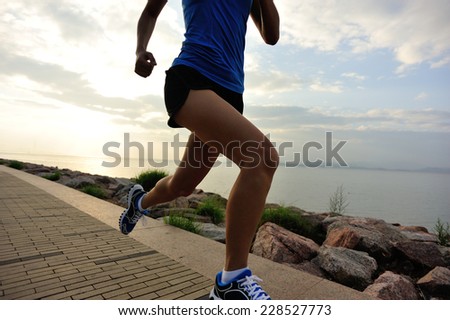 Runner athlete running at seaside. woman fitness  jogging workout wellness concept.