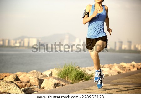Runner athlete running at seaside city