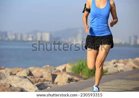 Runner athlete running at seaside city