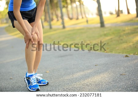woman runner sports injured leg