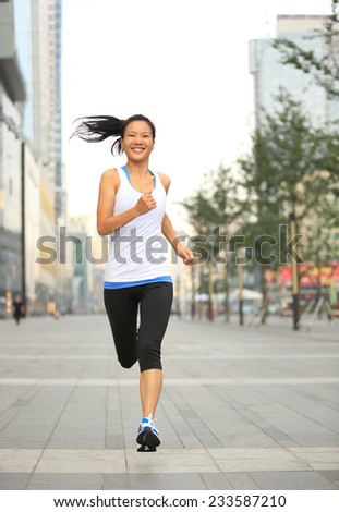 Runner athlete running on city road. woman fitness jogging workout wellness concept.