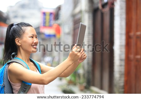 young asian woman tourist hold blank digital tablet