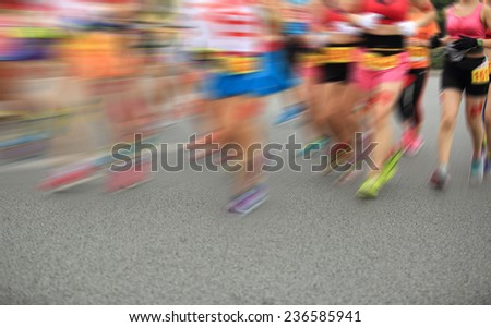 Unidentified marathon athletes legs running on  city road