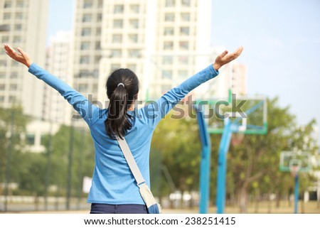 woman college student excited and raised hands in college