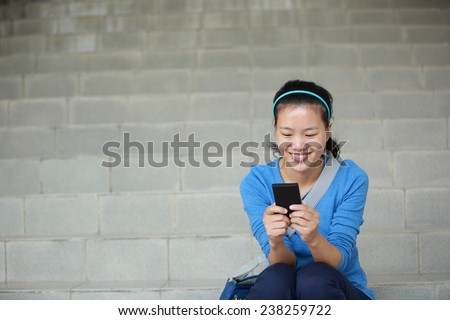college student use smart phone sit on stairs