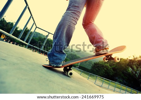 woman legs skateboarding at skatepark ramp