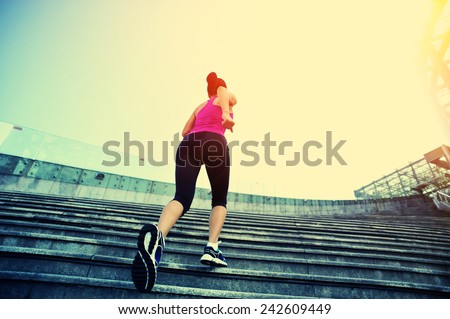 runner athlete running on stairs. woman fitness jogging workout wellness concept.