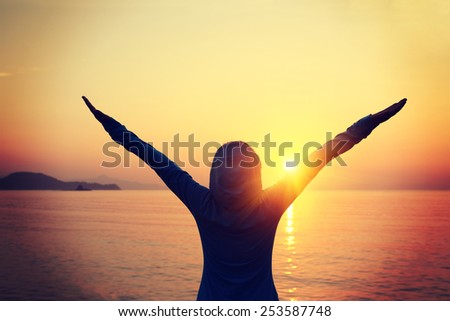 silhouette cheering woman open arms sunrise seaside
