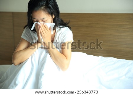 cough woman sneeze nose on bed