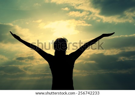freedom woman open arms under the sunrise at seaside