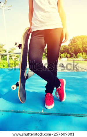 skateboarding woman legs at skatepark