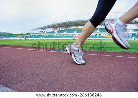 young fitness woman runner legs  running on track