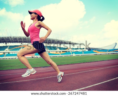 young fitness woman runner  running on track