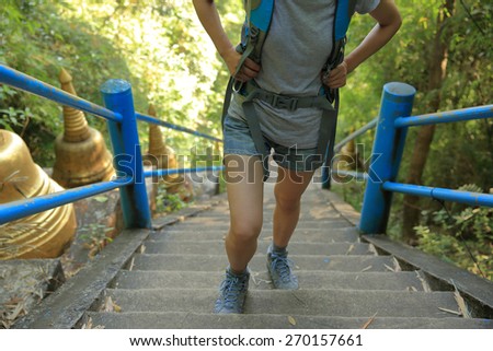 woman hiker climbing stairs at mountain peak
