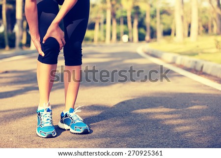 woman runner hold her sports injured leg woman runner hold her sports injured leg
