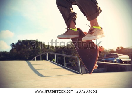 skateboarder legs doing a trick heelflip at skatepark,vintage effect