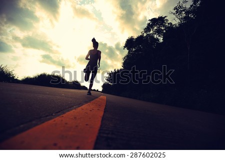 silhouette of fitness woman runner running at sunrise seaside trail,vitnage effect