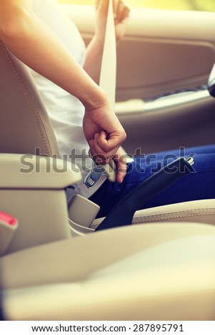 woman driver buckle up the seat belt before driving car,vintage effect