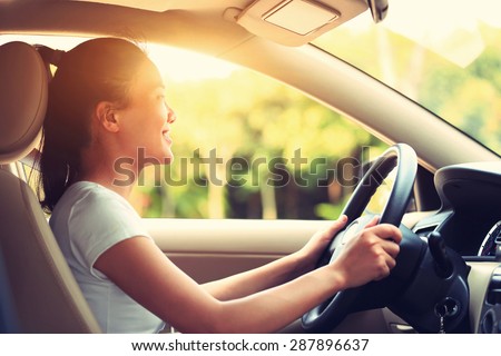 young asian woman driver driving a car,vintage effect