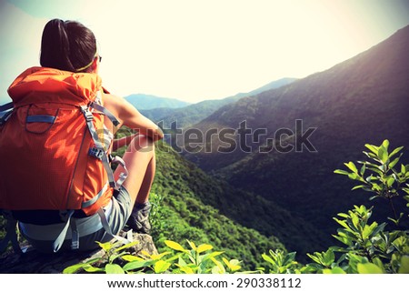 young woman backpacker  enjoy the view at mountain peak,vintage effect
