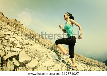 Runner athlete running on chinese great wall . woman fitness jogging workout wellness concept.