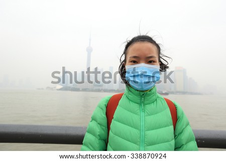 worried young woman wear a mask at the pollution city