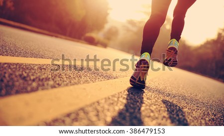 young fitness woman runner athlete legs running at road