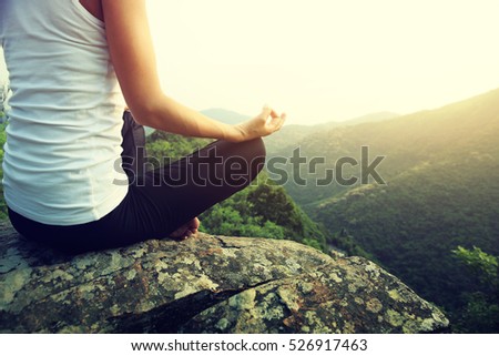 young fitness yoga woman at mountain peak