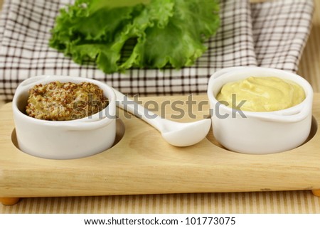 French mustard sauce in white gravy boat