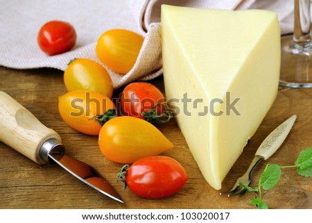 piece of  cheese, tomato and cheese knife