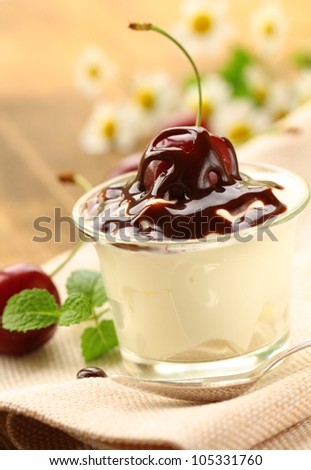 dairy dessert with chocolate sauce and cherries