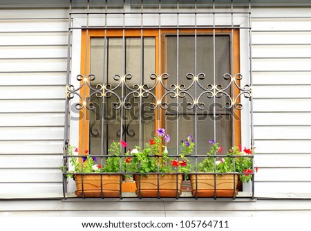 window on the wall, decorated with flowers and the lattice